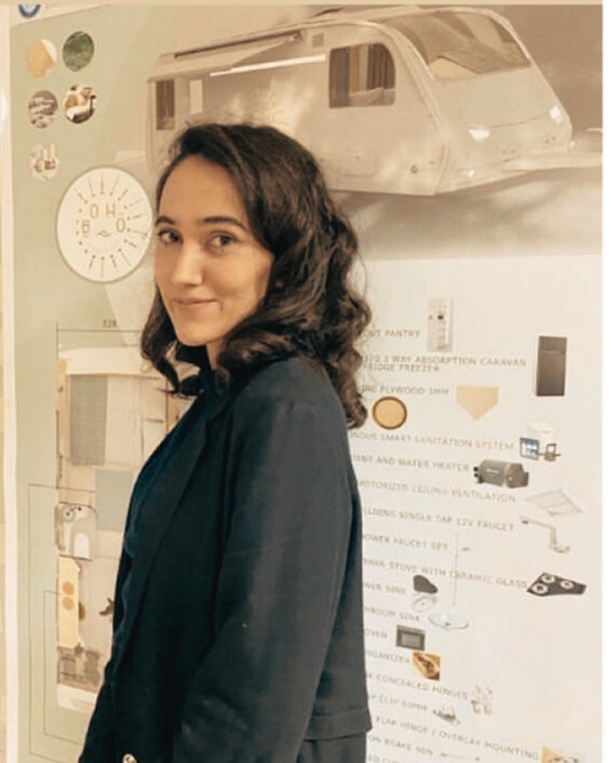 Yağmur in front of a product design presentation board
