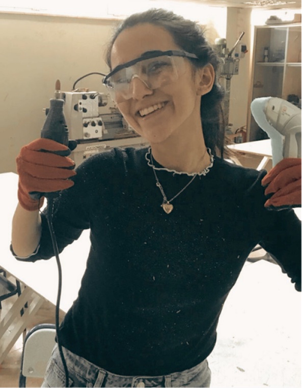 Yağmur in a workshop with safety glasses and a drill